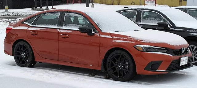 blazing orange 2022 honda civic si in the snow