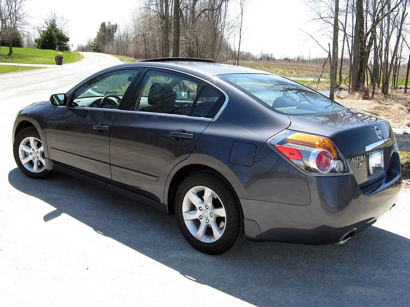 Black Nissan Altima parked outside