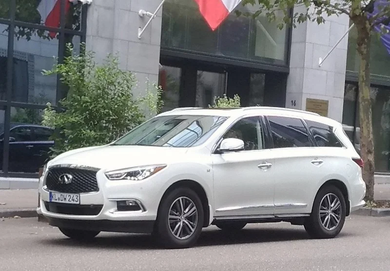 White Infiniti QX60 parked on a street