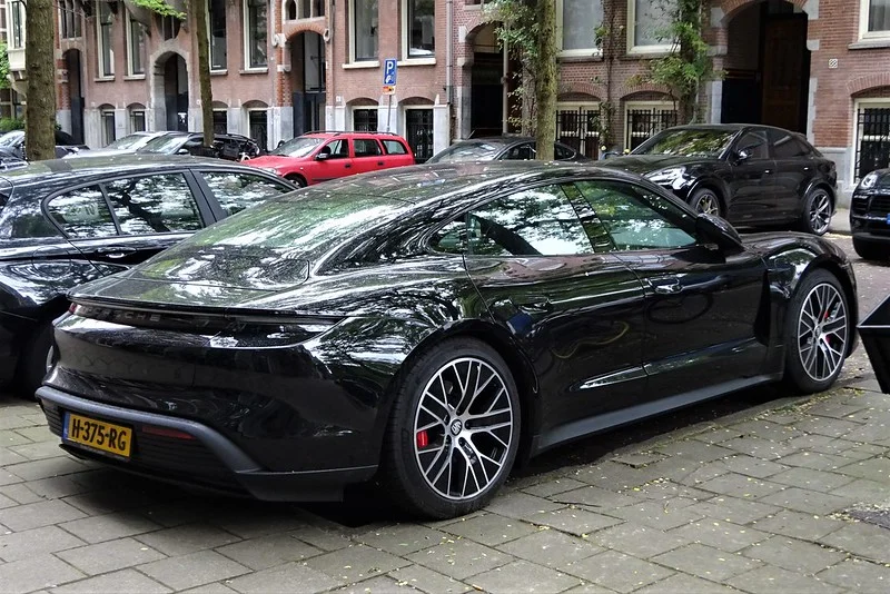 Black Porsche Taycan on a cobblestone street