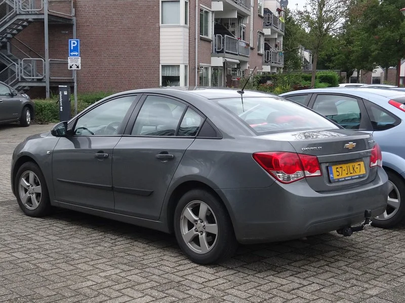 Silver Chevy Cruze parked on a brick road