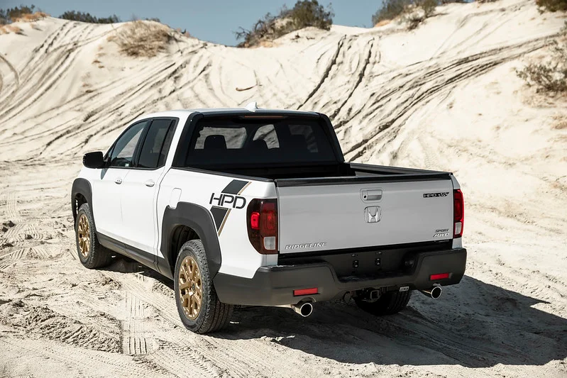 White Honda Ridgeline in sand dunes