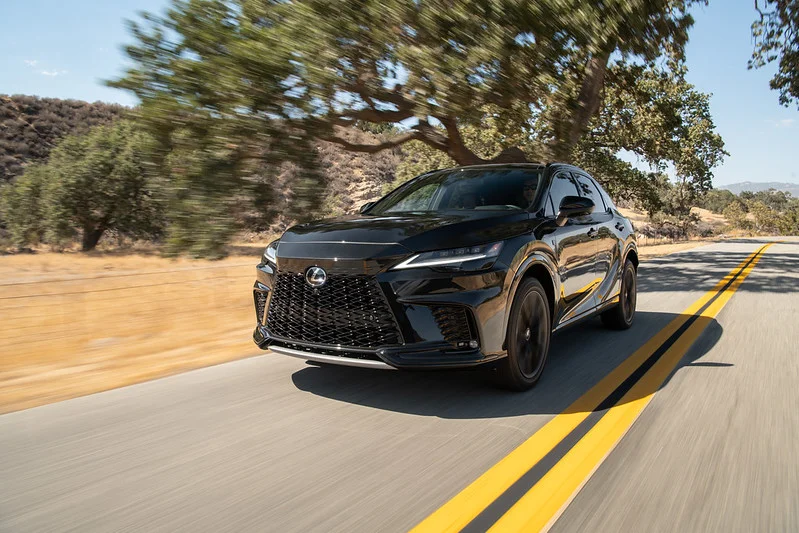 Lexus RX driving down a road