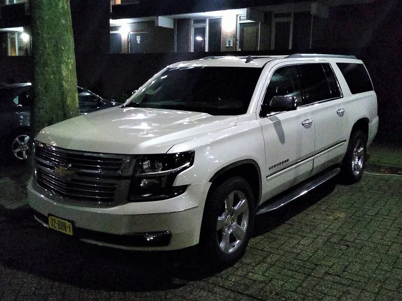 White Chevy Suburban at night