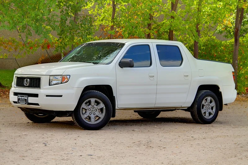 White Honda Ridgeline parked in the forest