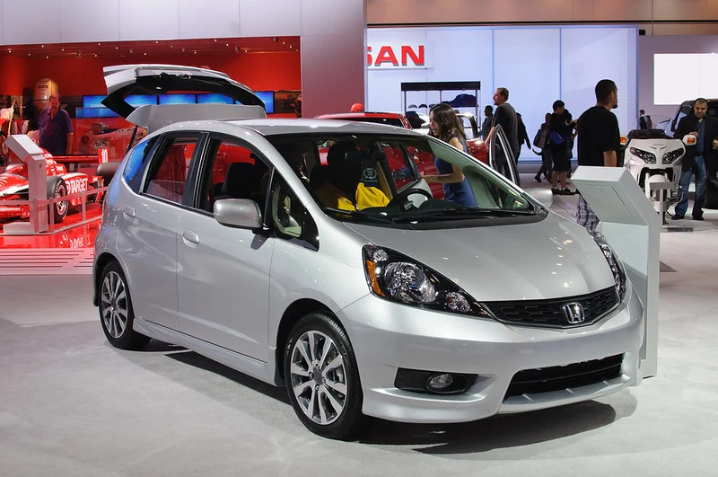 Silver Honda Fit in a showroom