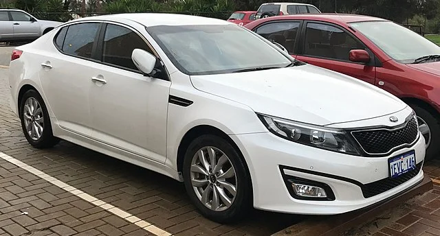 White Kia Optima in a parking lot