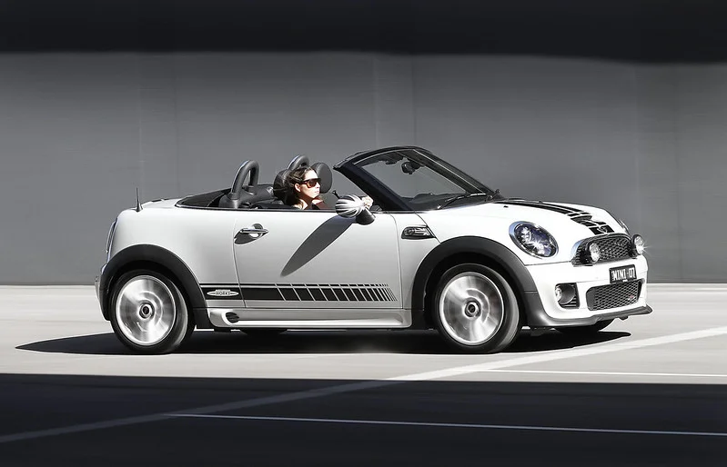 Woman driving a white MINI Cooper Roadster