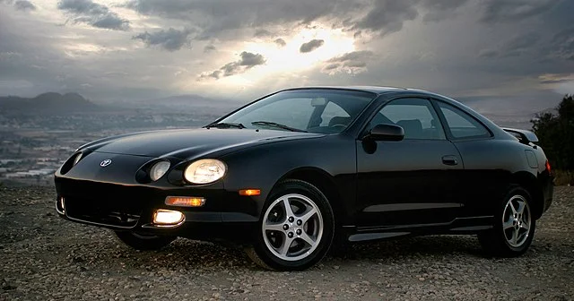 Black Toyota Celica on the beach