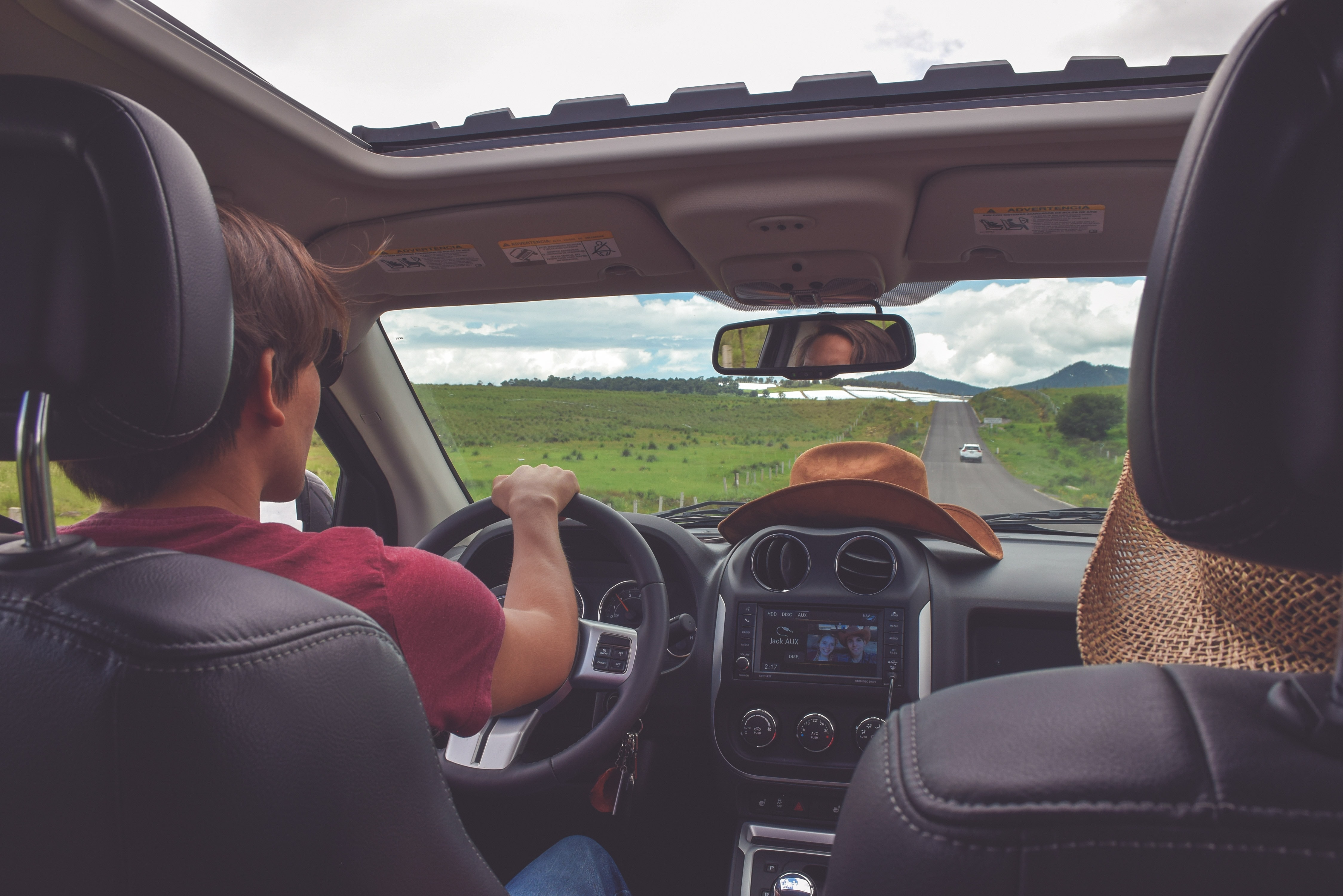 peope driving in a car with a sunroof