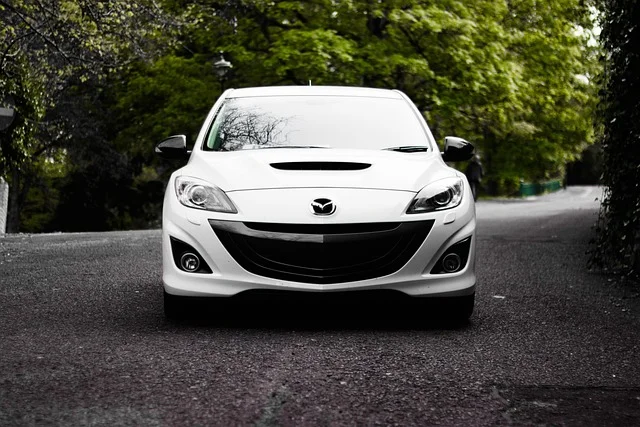 White Mazda parked on a road