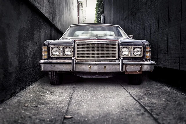 Front grill of a car parked in an alley