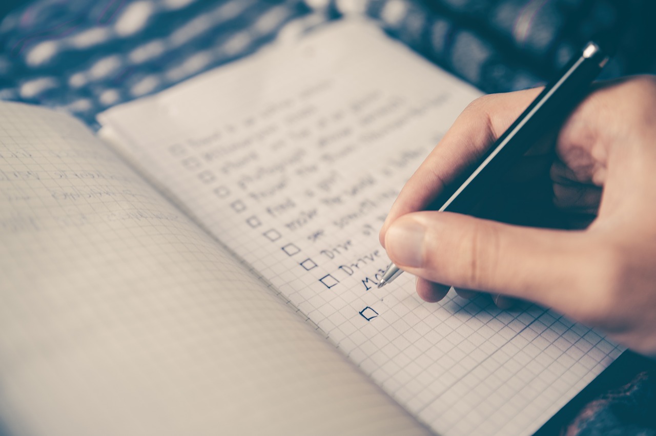 Photo of a person writing out a checklist