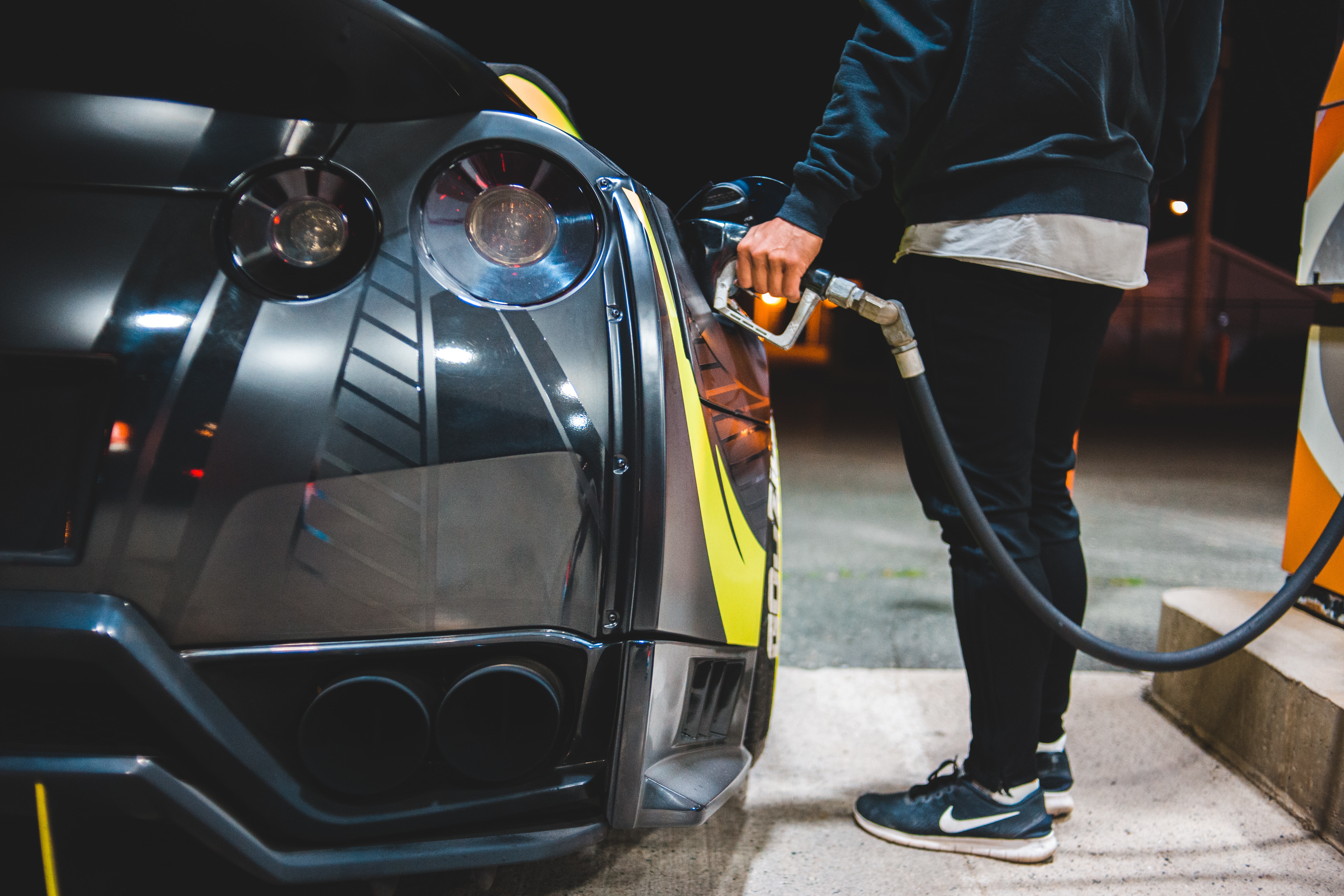 man filling up at gas pump