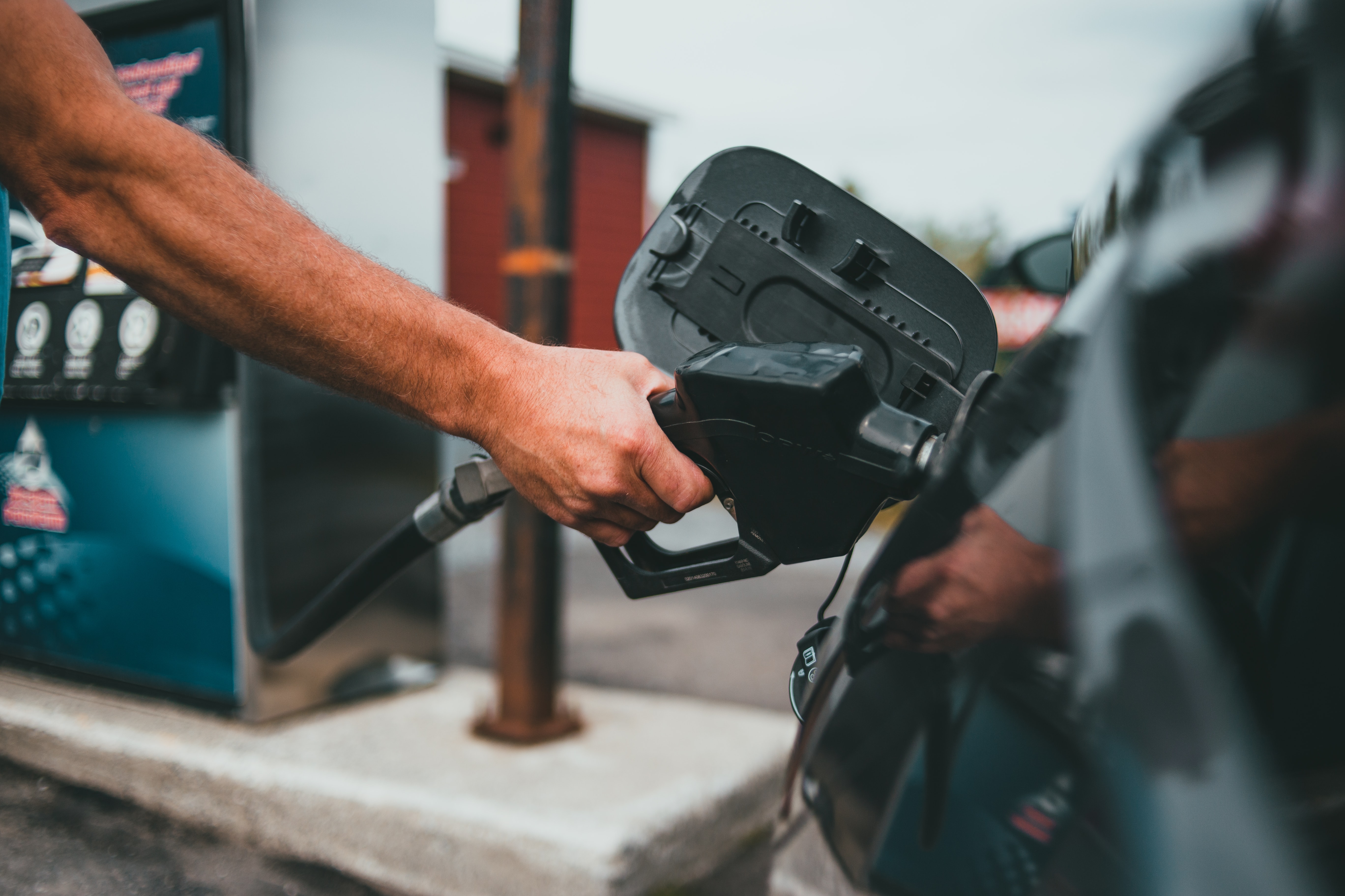 man putting gas in his car