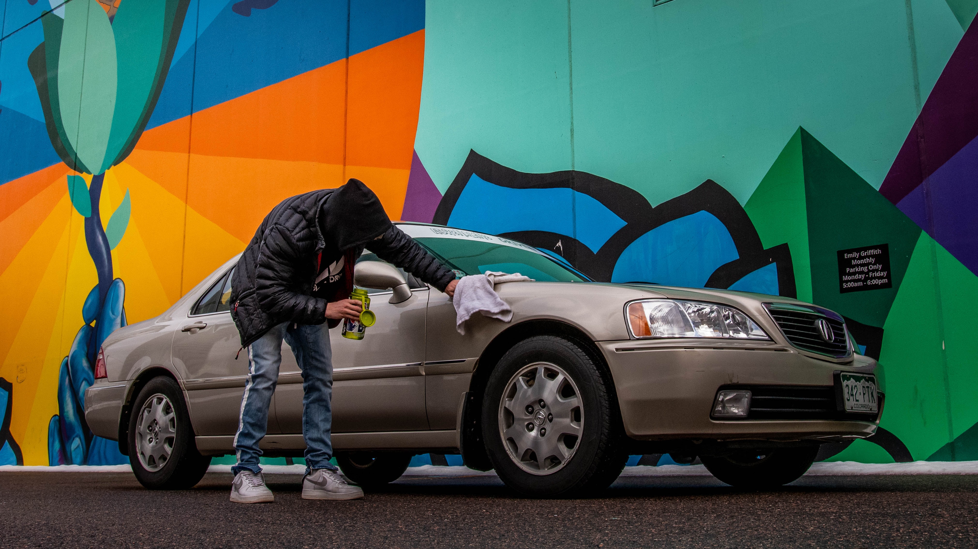 man cleaning beige used car