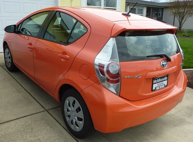 Orange Prius in a driveway